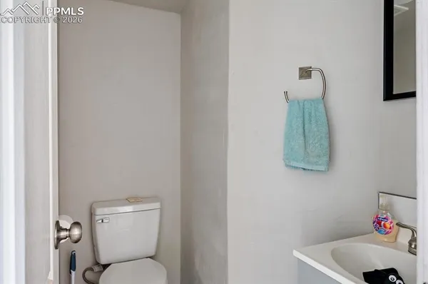 a white toilet sitting next to a bathroom sink