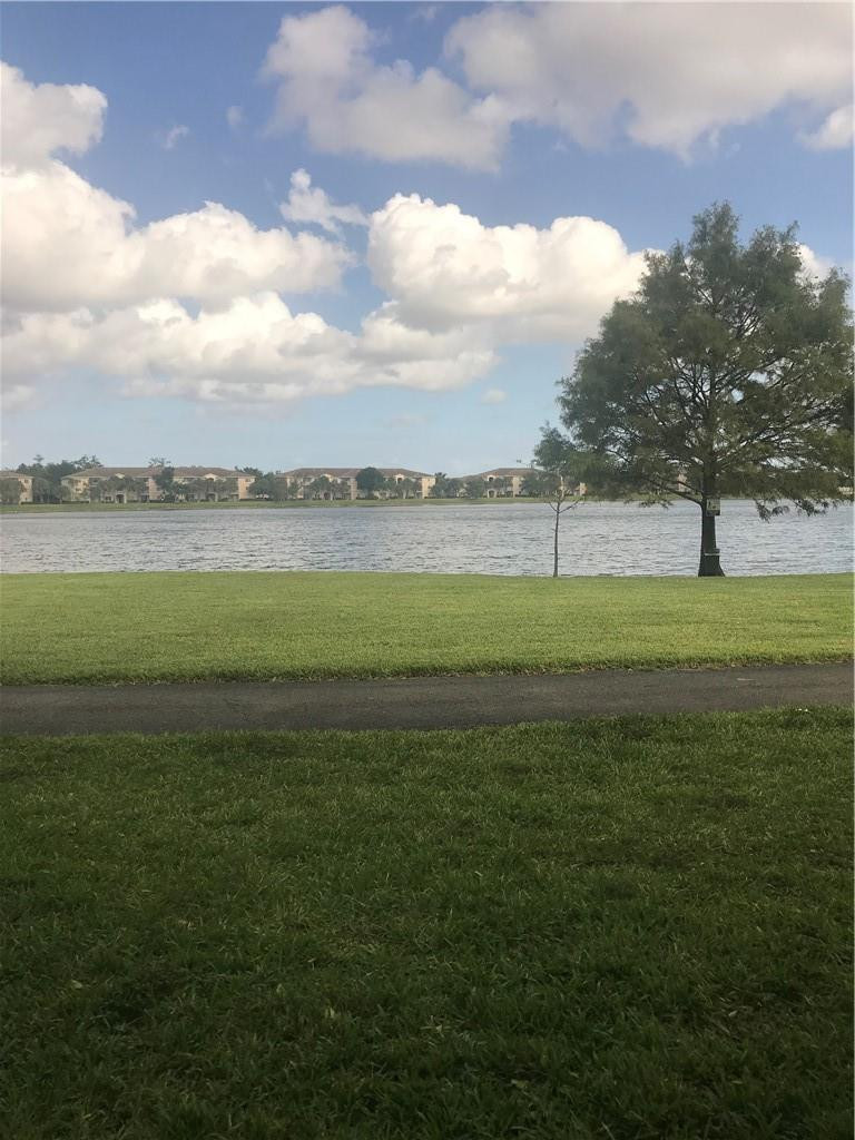 5025 Wiles Road, Unit 207 Coconut Creek, FL 33073 - Photo 6 of 6 a view of a lake with a big yard