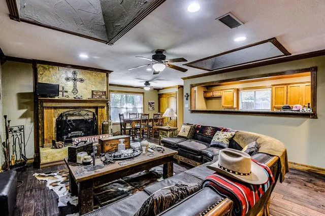 a living room with furniture a flat screen tv and a fireplace