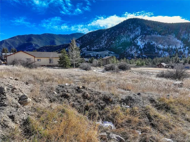 a view of dirt road with a building in the background