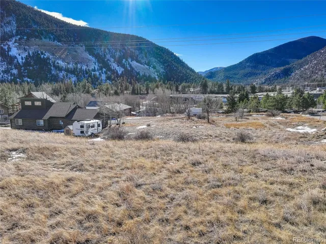 a view of a yard covered with snow in the background