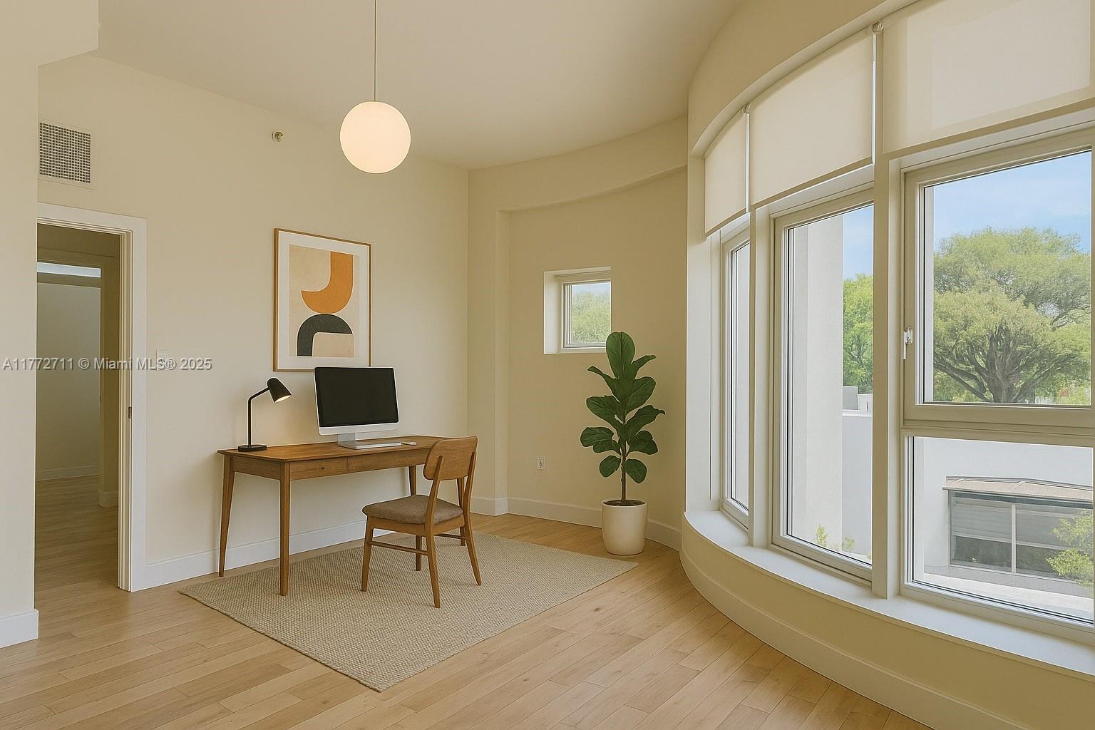 6701 Biscayne Boulevard, Unit 201 Miami, FL 33138 - Photo 12 of 22 a view of a workspace room with wooden floor and windows