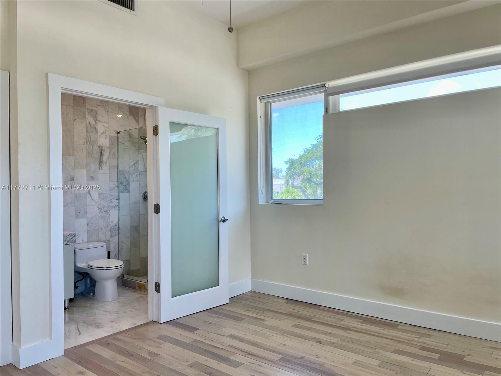 6701 Biscayne Boulevard, Unit 201 Miami, FL 33138 - Photo 18 of 22 a view of a bathroom with a toilet and a sink