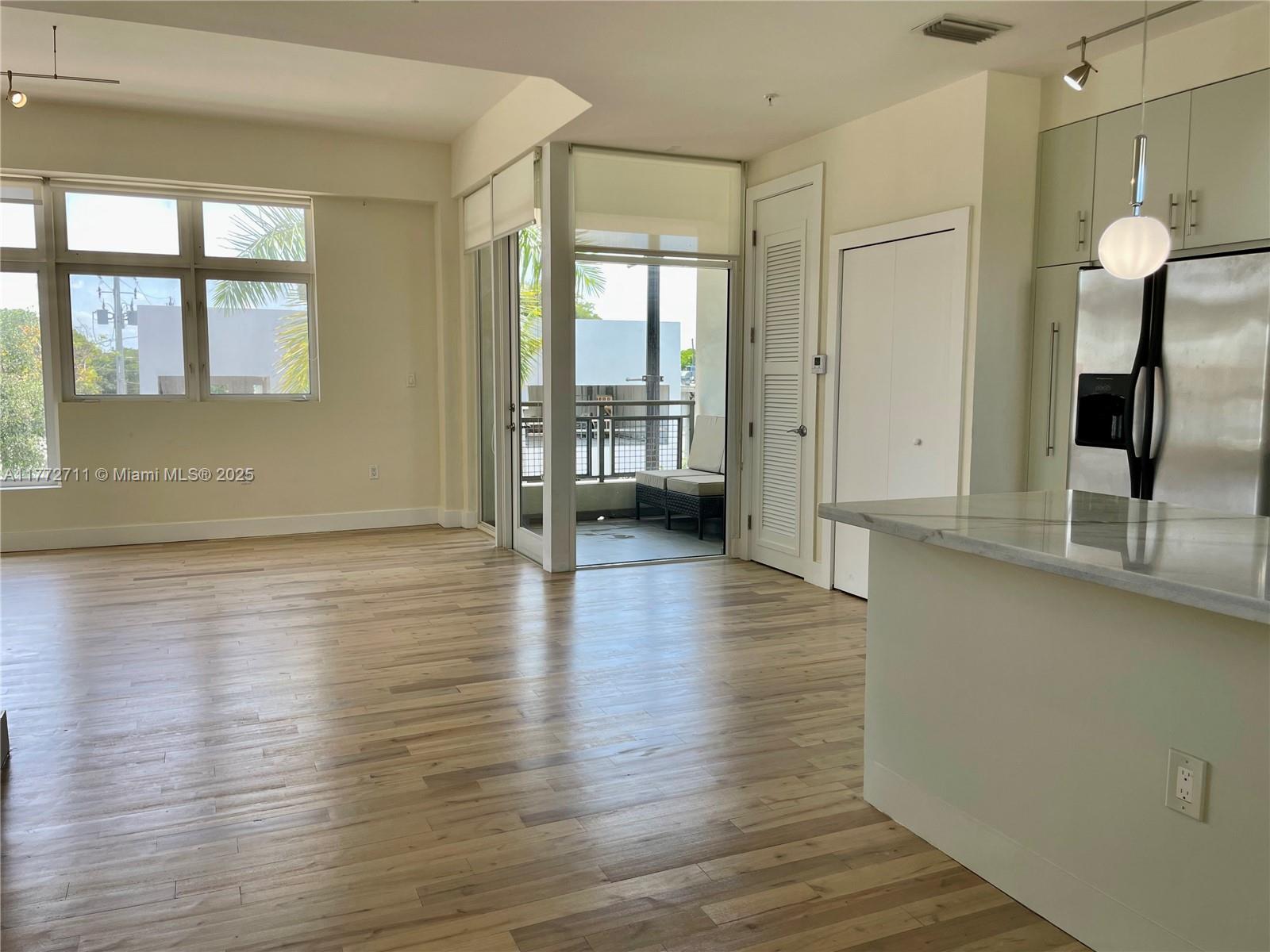 6701 Biscayne Boulevard, Unit 201 Miami, FL 33138 - Photo 8 of 22 a view of a room with wooden floor and a window