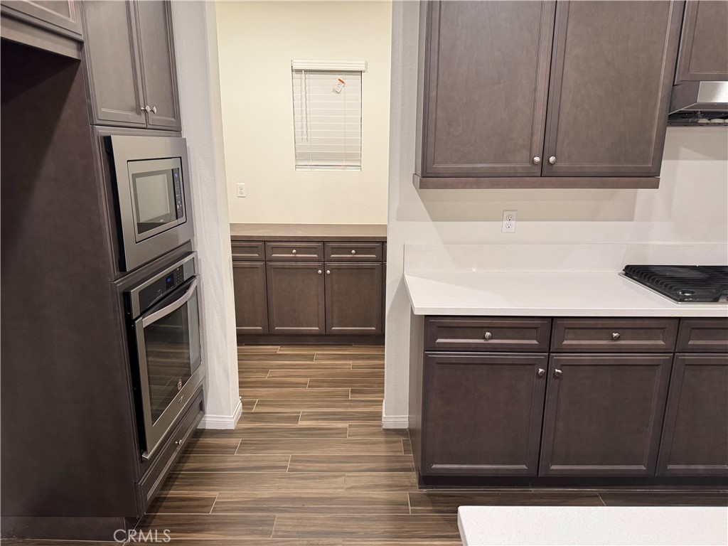 28582 Buttercup Way Moreno Valley, CA 92555 - Photo 13 of 55 a kitchen with granite countertop cabinets and black appliances