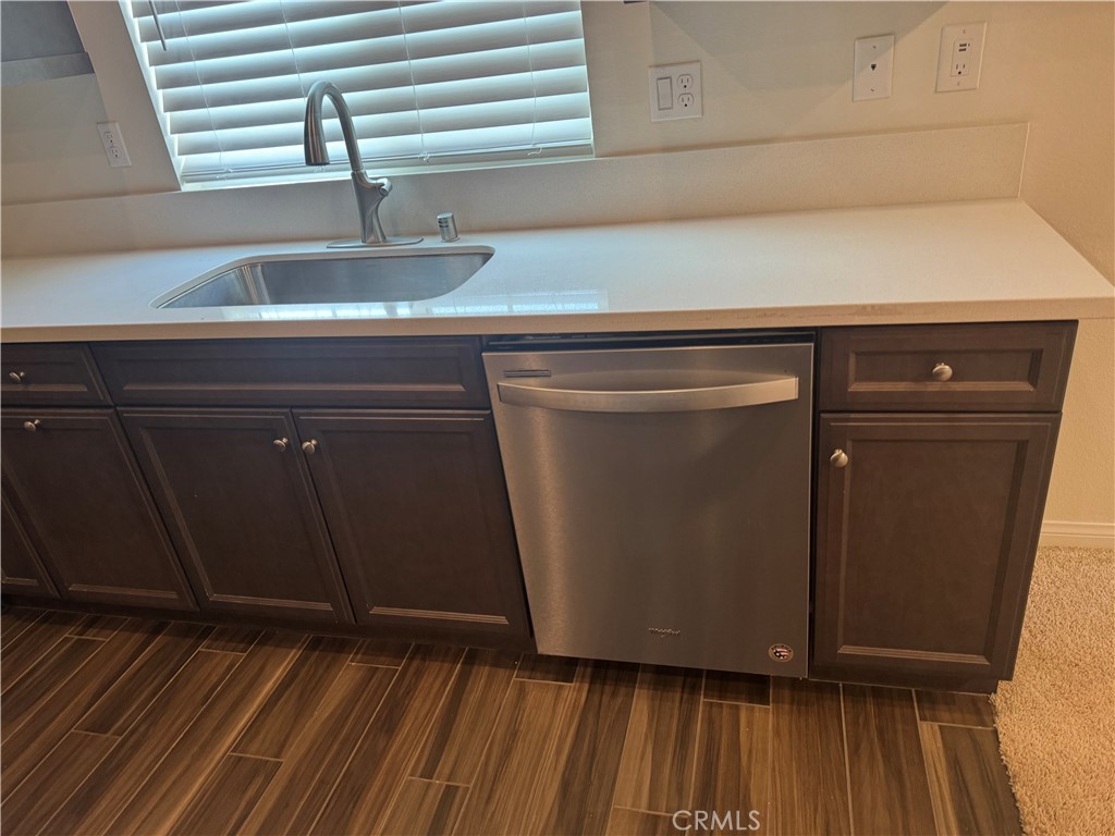 28582 Buttercup Way Moreno Valley, CA 92555 - Photo 15 of 55 a kitchen with cabinets and wooden floor