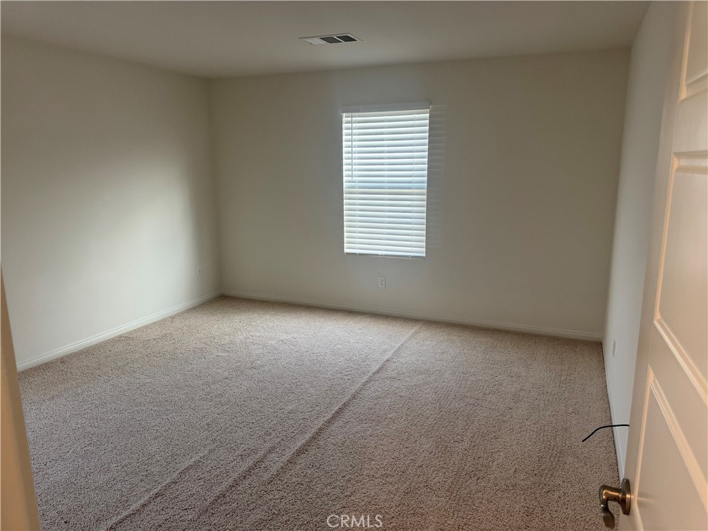 28582 Buttercup Way Moreno Valley, CA 92555 - Photo 36 of 55 a view of an empty room with a window