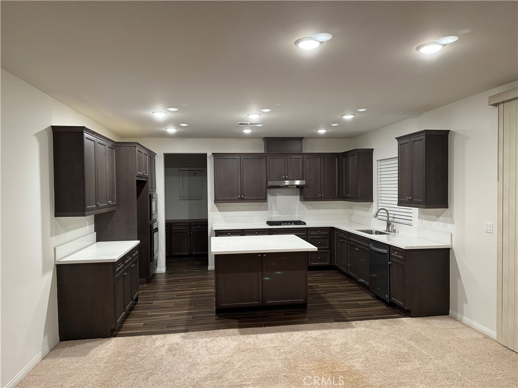 28582 Buttercup Way Moreno Valley, CA 92555 - Photo 6 of 55 a large kitchen with kitchen island a sink stainless steel appliances and cabinets
