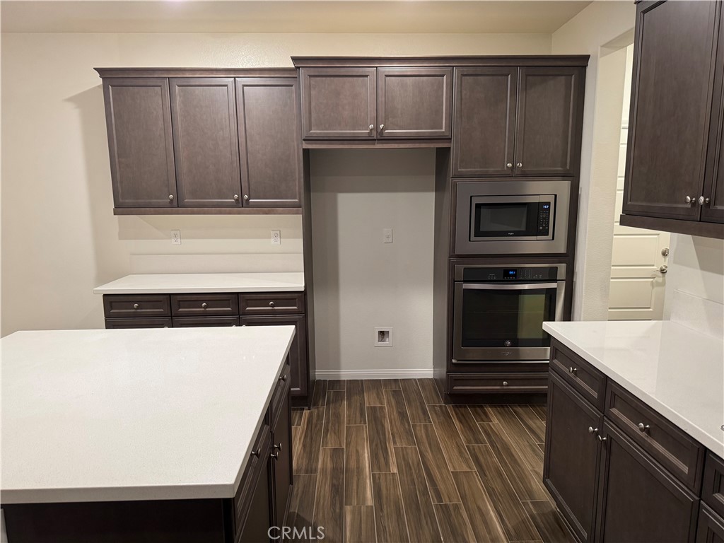 28582 Buttercup Way Moreno Valley, CA 92555 - Photo 7 of 55 a kitchen with a refrigerator stove and cabinets