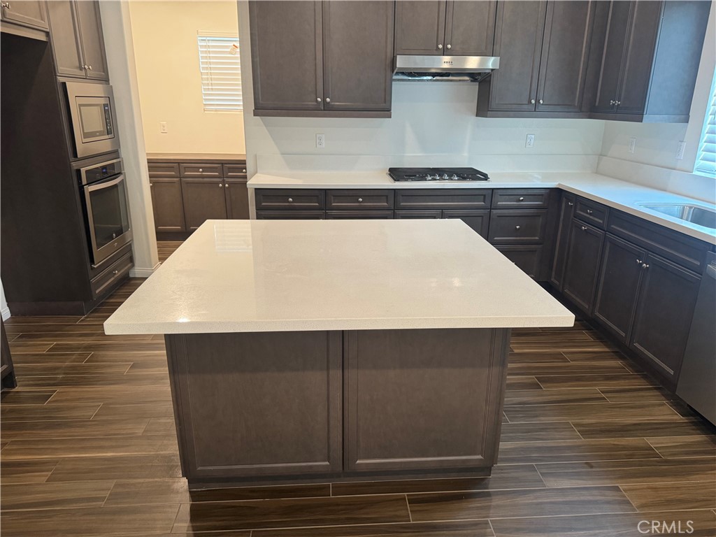 28582 Buttercup Way Moreno Valley, CA 92555 - Photo 8 of 55 a kitchen with a sink and cabinets
