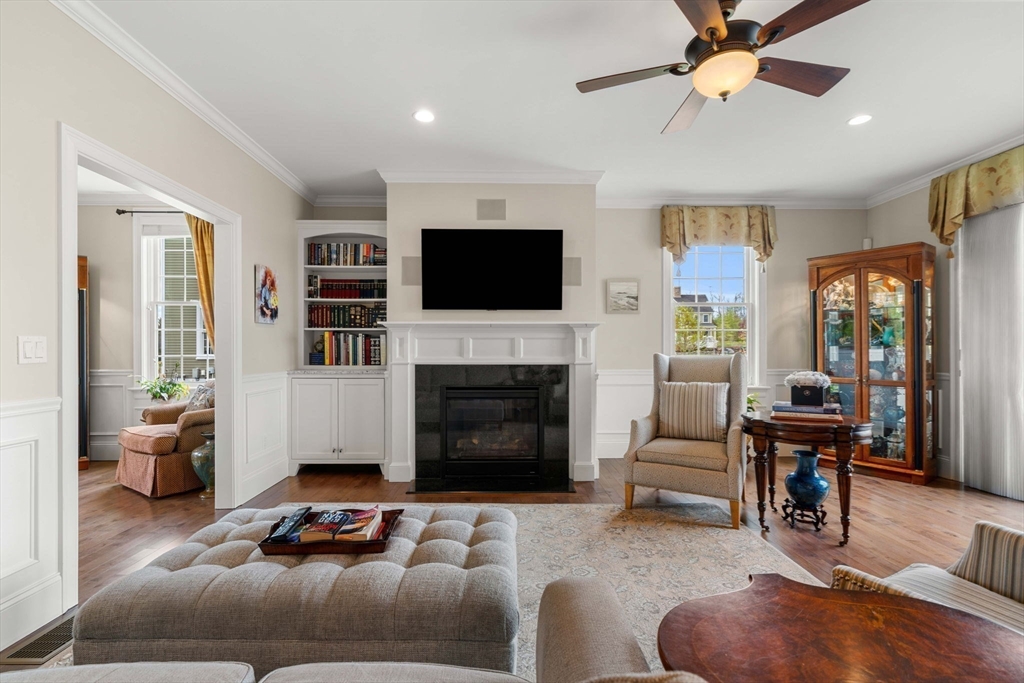 4 Point Shore Overlook Amesbury, MA 01913 - Photo 12 of 42 a living room with furniture a flat screen tv and a fireplace