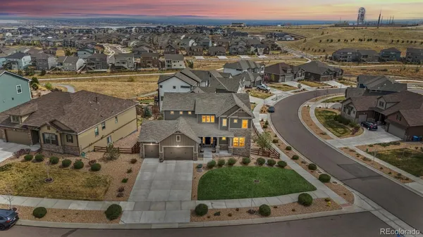 an aerial view of residential houses with outdoor space and parking