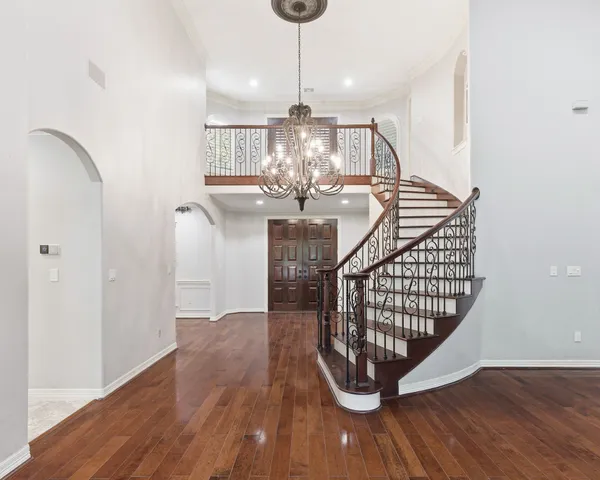 a view of a living room and kitchen with wooden floor