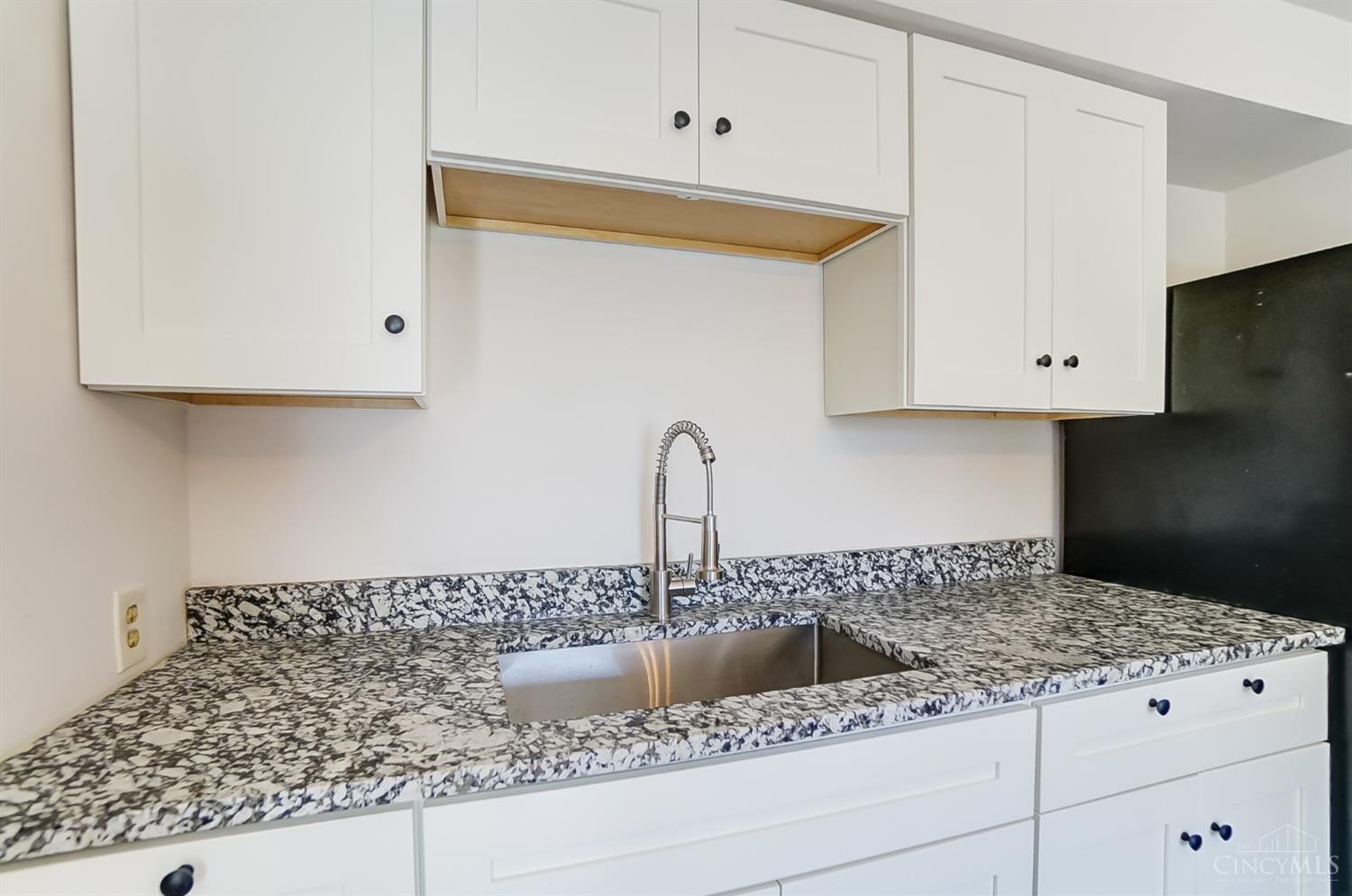 5754 Argus Road Cincinnati, OH 45224 - Photo 8 of 26 Kitchen features newly installed hardwood floors, wood/soft close cabinets, new granite counters, new stainless sink/faucet, new gas oven/range, and ceiling fan.