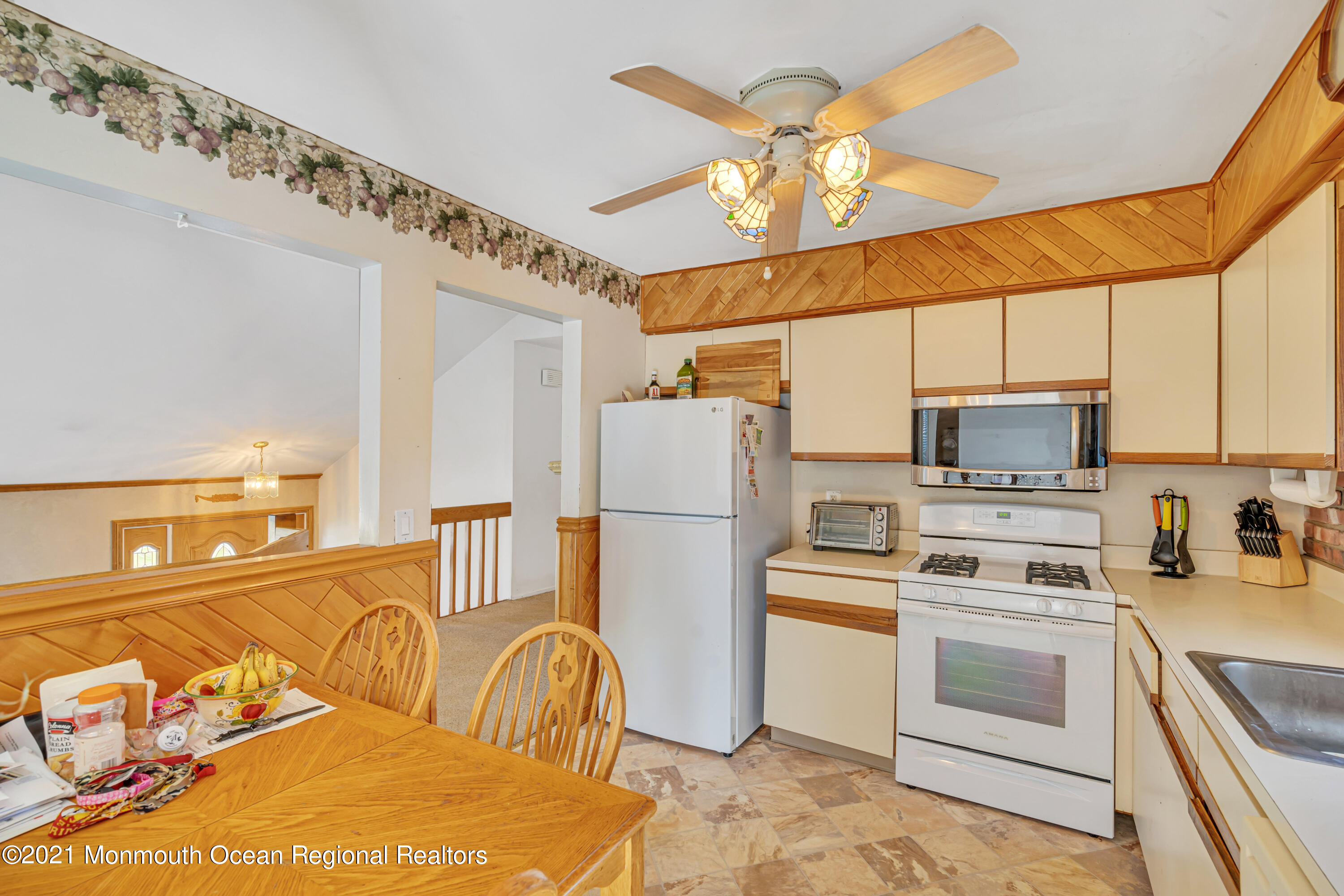 16 Marc Drive Howell, NJ 07731 - Photo 9 of 29 a kitchen with a refrigerator and a stove top oven
