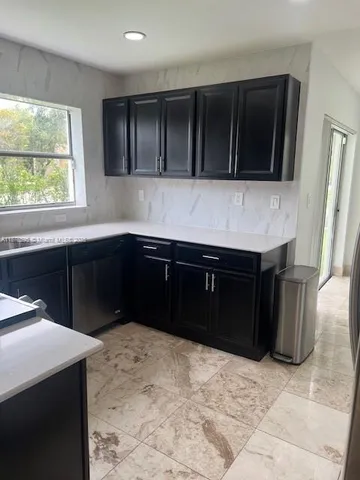 a kitchen with a sink and a stove