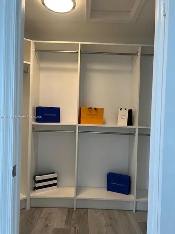 a en suite bathroom with a granite countertop toilet sink and mirror