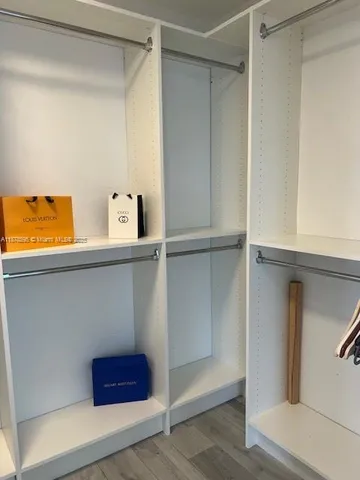 a white toilet sitting next to a shower