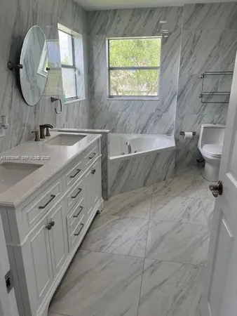 a bath tub sitting next to a window