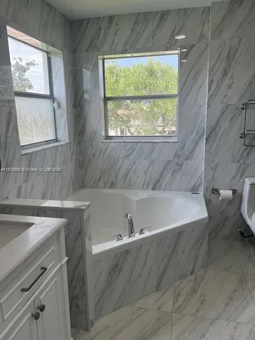 a bathroom with a sink and a mirror and vanity