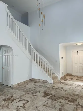 a view of staircase with white walls and stairs