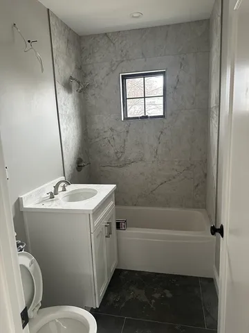a bathroom with a sink toilet and shower