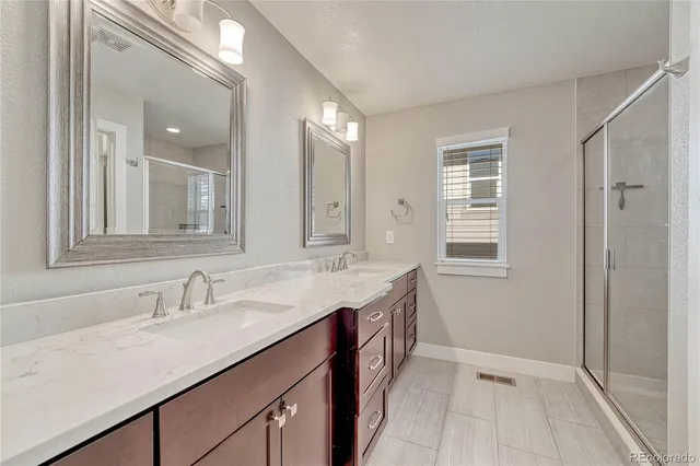 a bathroom with a sink double vanity and a mirror