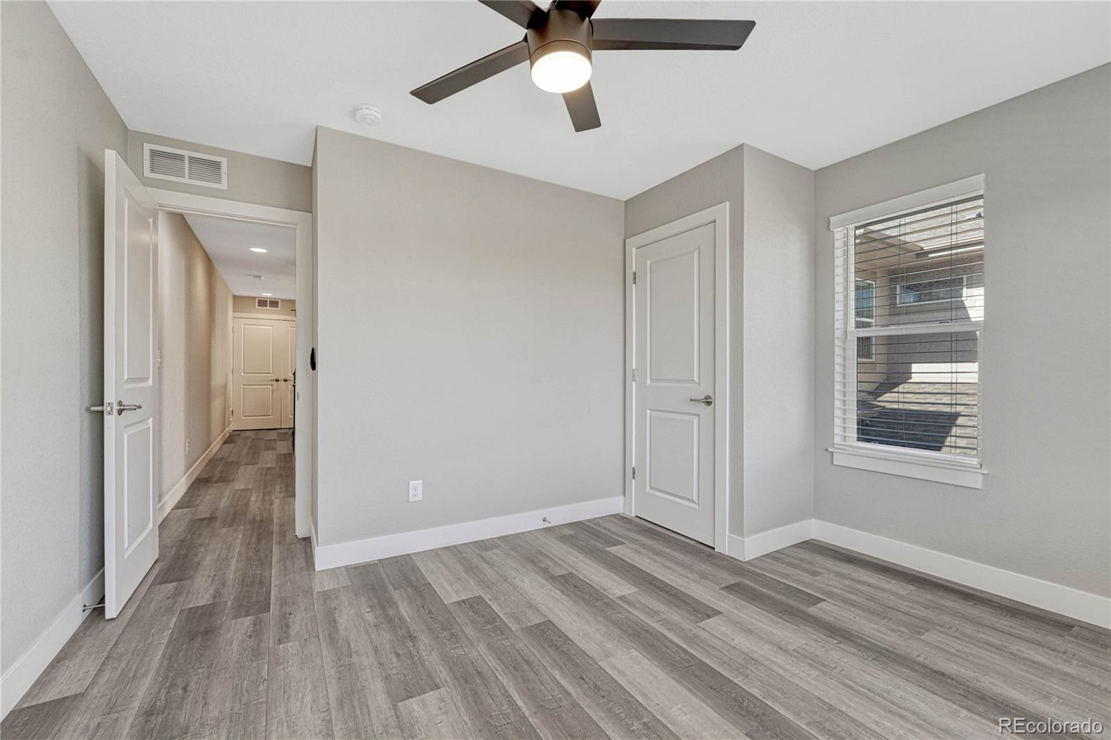 923 Raleigh Street Denver, CO 80204 - Photo 22 of 35 a view of a livingroom with wooden floor and a ceiling fan