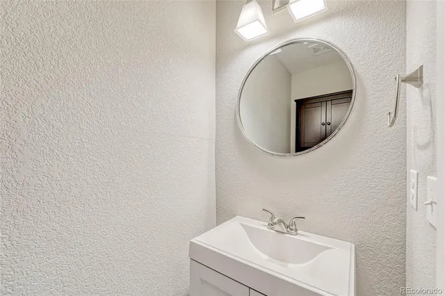 a bathroom with a sink and mirror