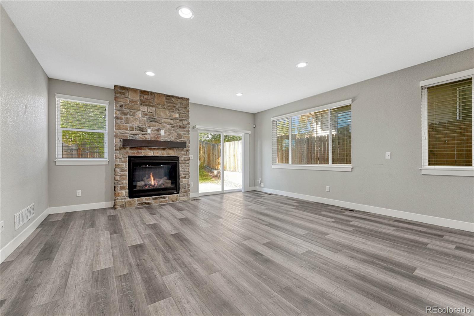 923 Raleigh Street Denver, CO 80204 - Photo 5 of 35 an empty room with windows and fireplace