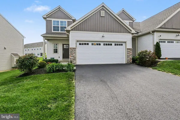 a view of house with garden and garage