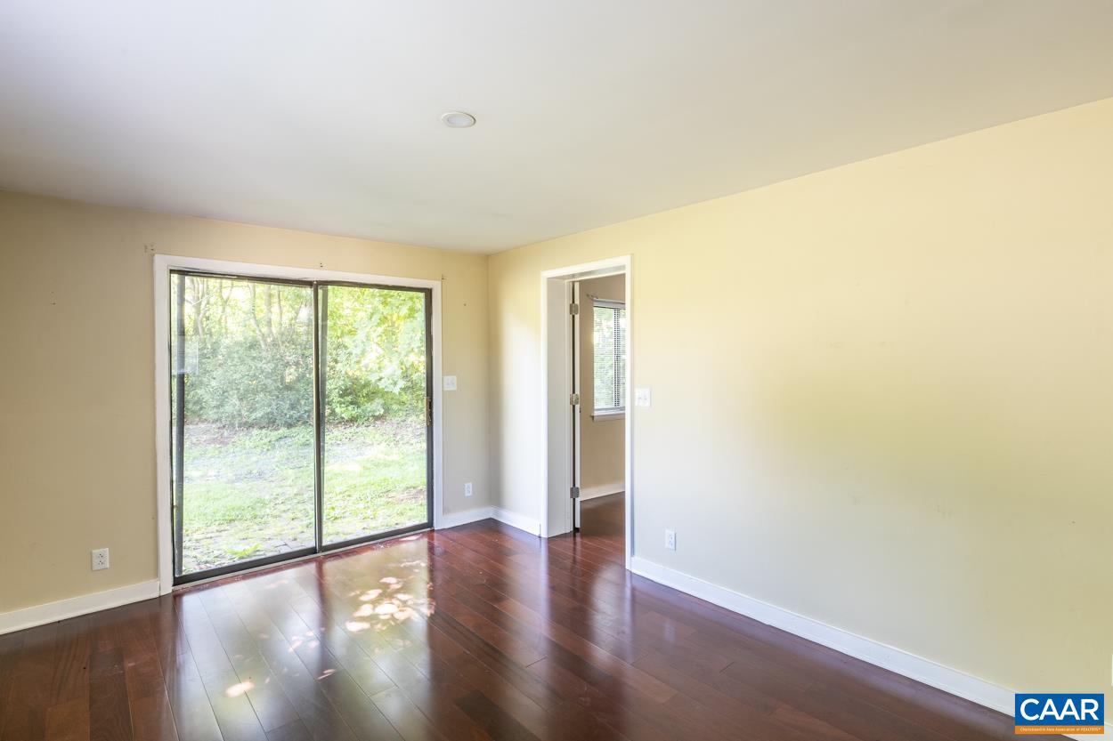 1118 Wolf Trap Road Charlottesville, VA 22911 - Photo 46 of 64 a view of an empty room with wooden floor and a window