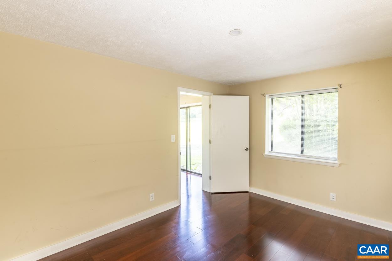 1118 Wolf Trap Road Charlottesville, VA 22911 - Photo 54 of 64 an empty room with wooden floor and windows