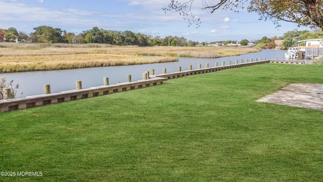 a view of a lake with houses in the back