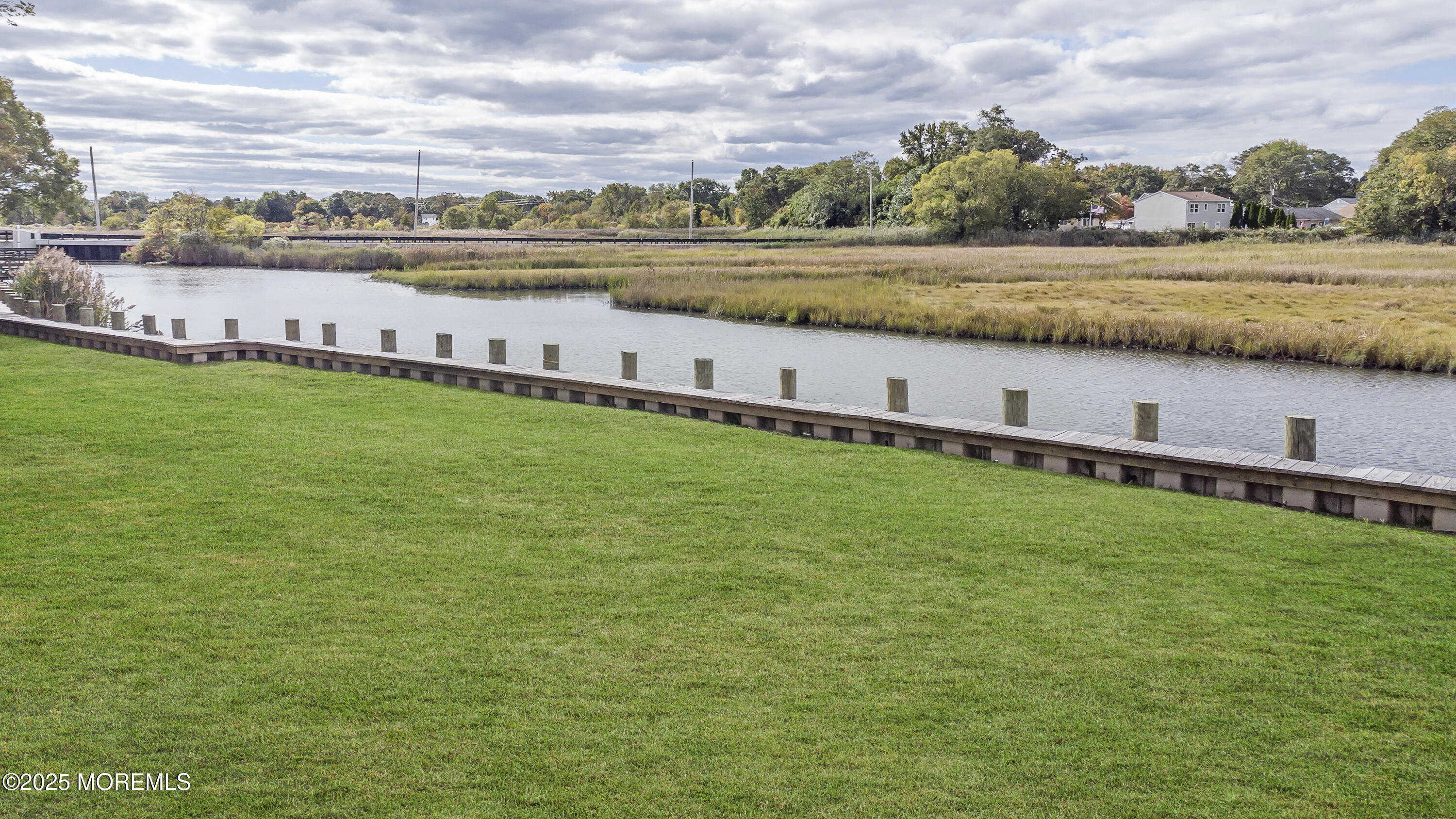 103 Creek Road Keansburg, NJ 07734 - Photo 2 of 34 a view of a lake with a big yard and large trees