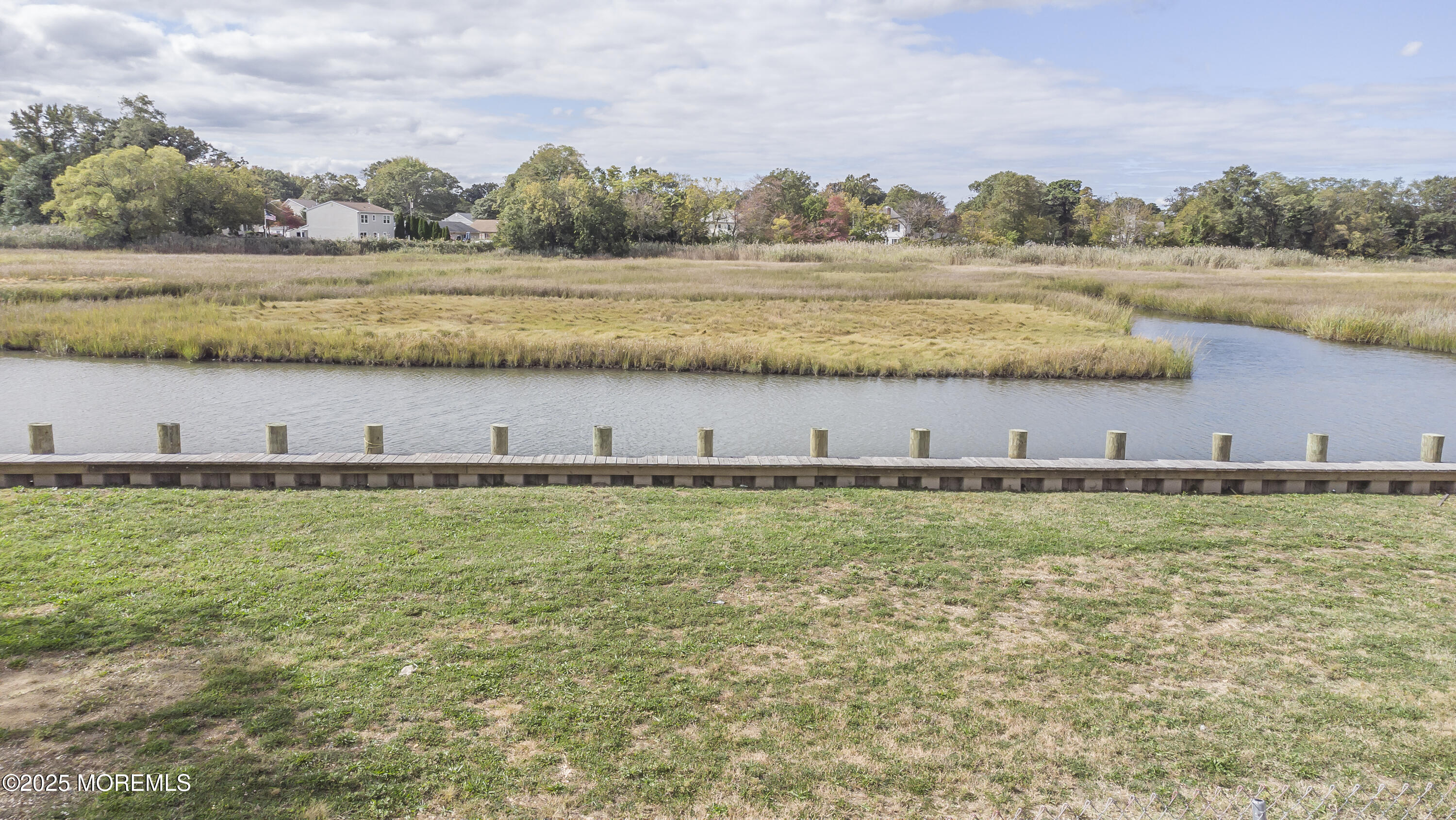 103 Creek Road Keansburg, NJ 07734 - Photo 7 of 34 a view of a lake with green landscape and trees