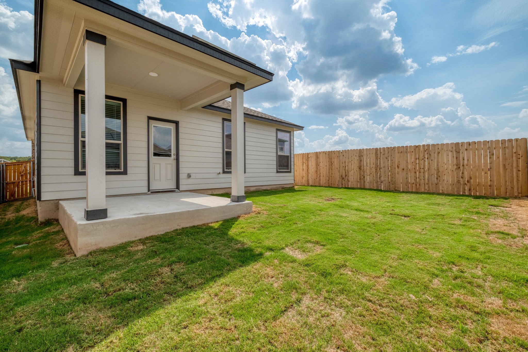 280 Feathers Street Jarrell, TX 76537 - Photo 27 of 28 a view of a backyard with potted plants and wooden fence