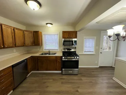 a kitchen with stainless steel appliances granite countertop a stove and a refrigerator