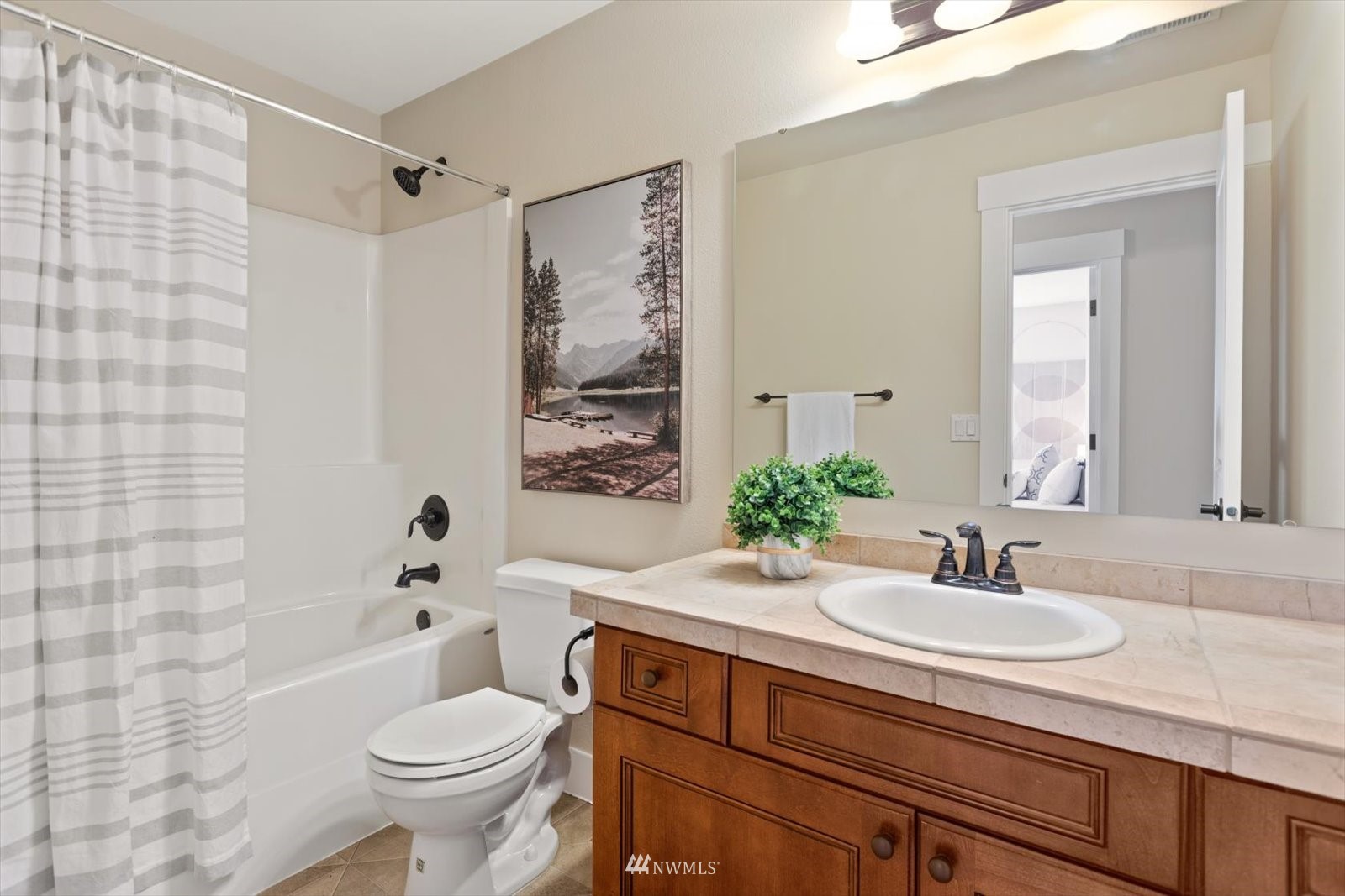 5014 Northeast 24th Street Renton, WA 98059 - Photo 29 of 37 a bathroom with a sink toilet a mirror and shower