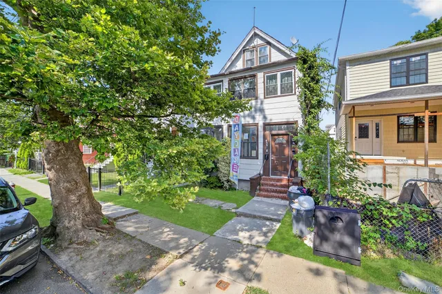 a front view of a house with a garden