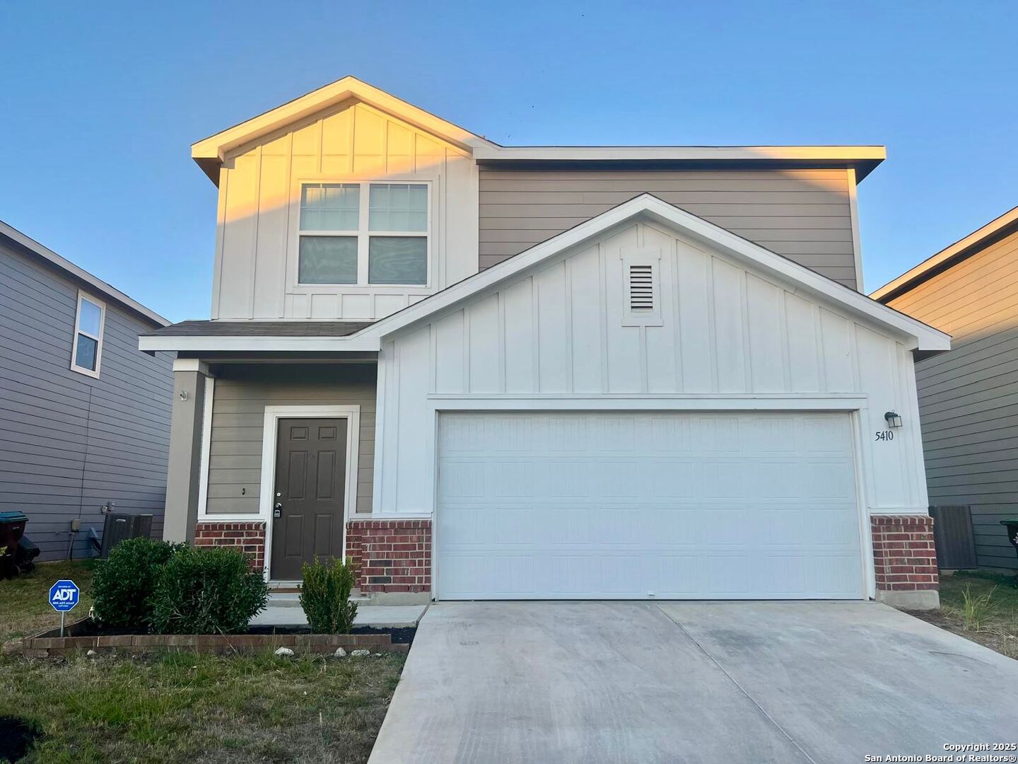 a front view of house along with yard and green space