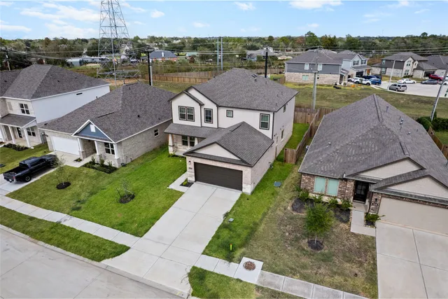an aerial view of a house with garden space and street view