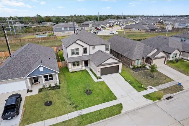 an aerial view of a house with garden space and street view