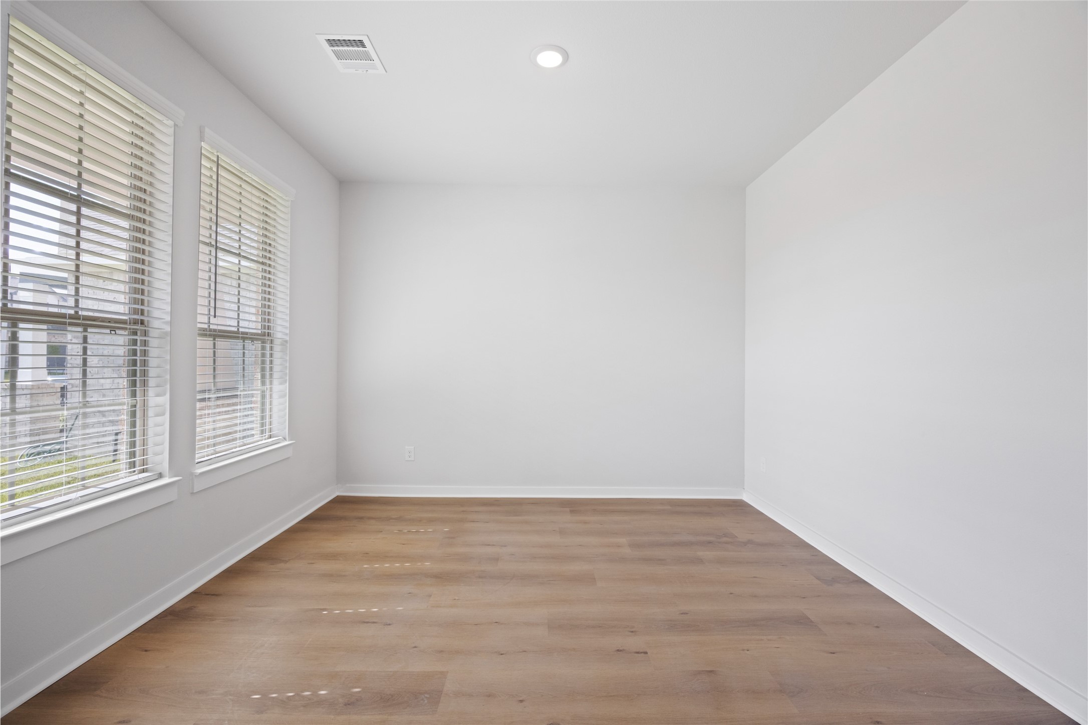 8322 Amethyst Valley Lane Angleton, TX 77515 - Photo 17 of 39 an empty room with wooden floor and windows