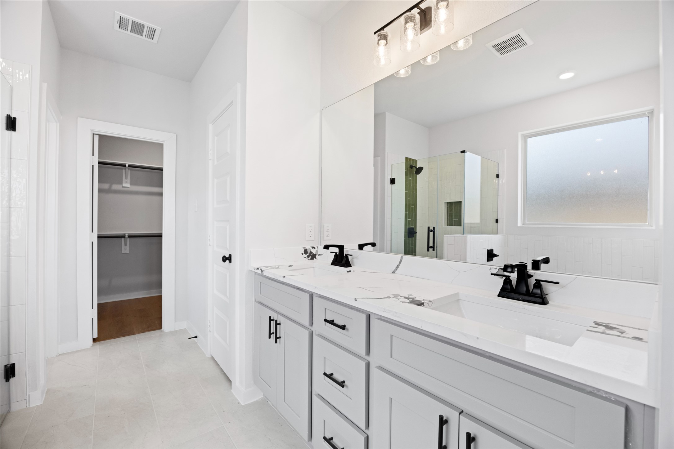 8322 Amethyst Valley Lane Angleton, TX 77515 - Photo 29 of 39 a bathroom with a double vanity sink and mirror