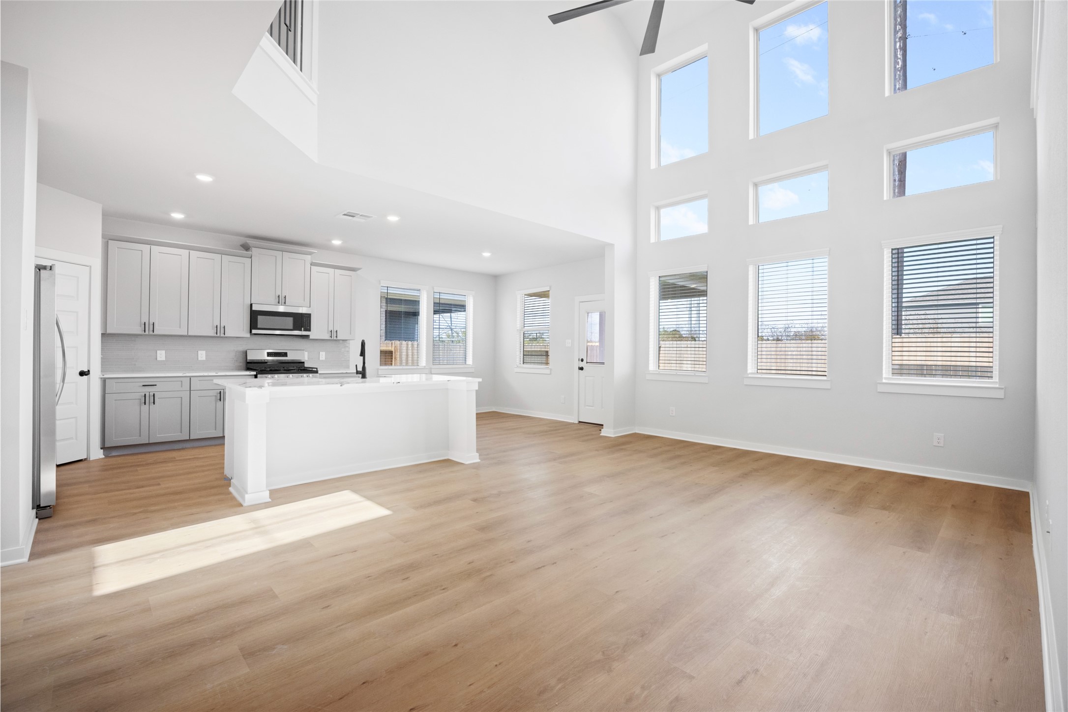 8322 Amethyst Valley Lane Angleton, TX 77515 - Photo 5 of 39 a view of a kitchen with kitchen island a sink wooden floor and stainless steel appliances