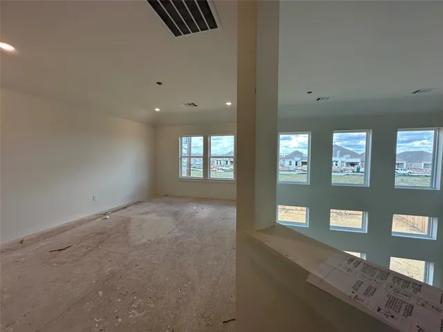 a view of an empty room with windows