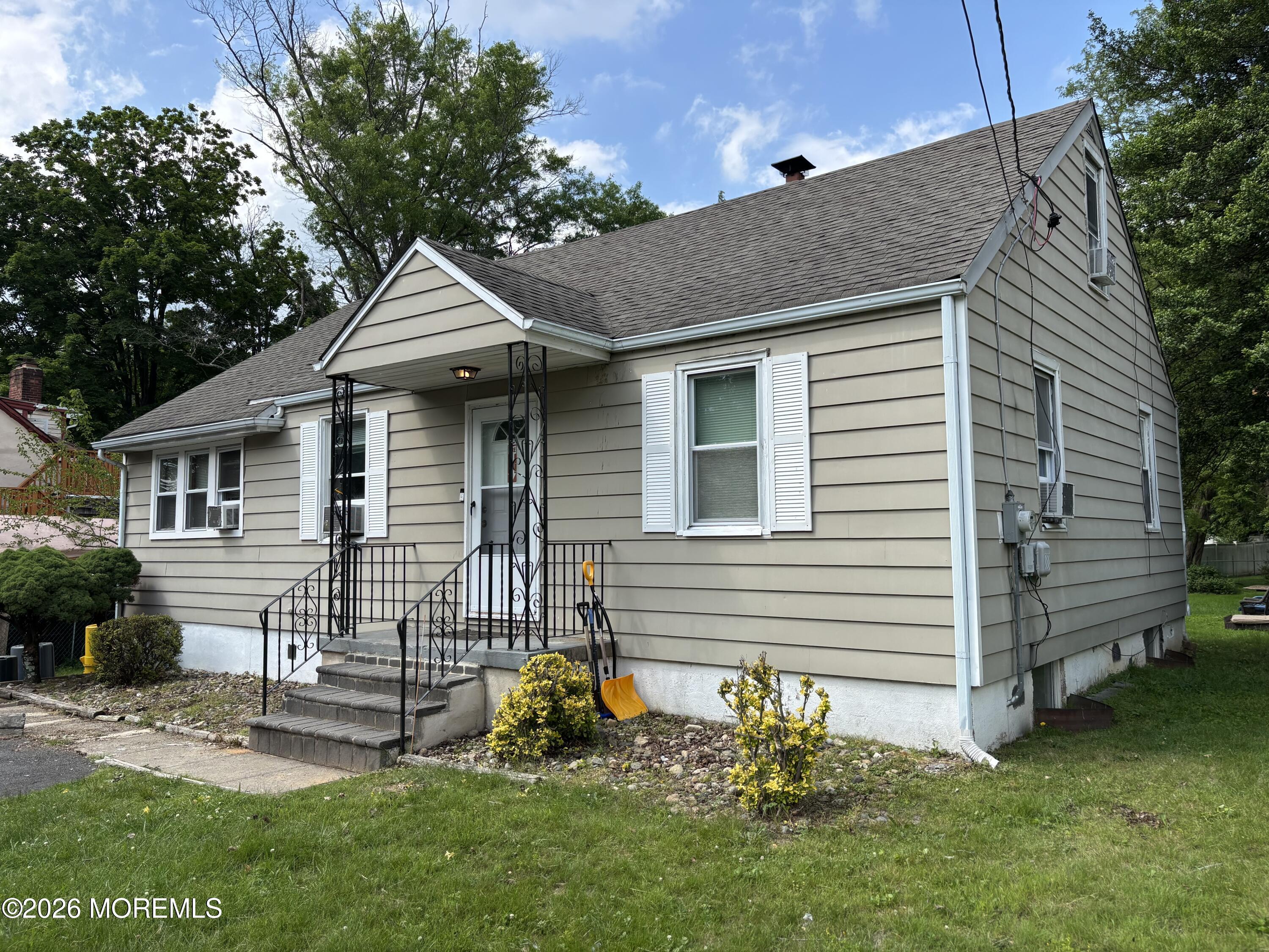 a front view of a house with a garden