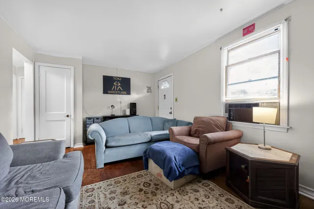 a living room with furniture a couch and a window