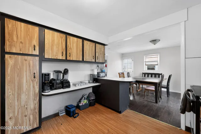 a view of a workspace with furniture and wooden floor